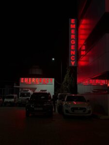 Emergency entrance at a hospital in Sahibzada Ajit Singh Nagar, India, at night.