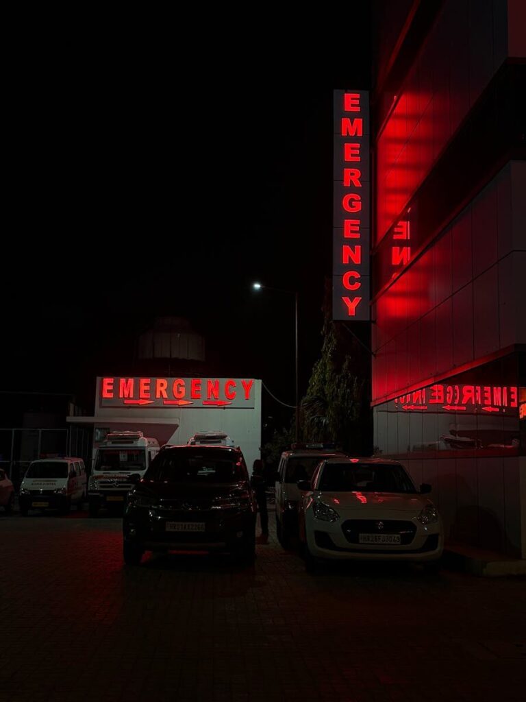 Emergency entrance at a hospital in Sahibzada Ajit Singh Nagar, India, at night.